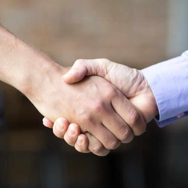 closeup-two-business-men-shaking-hands